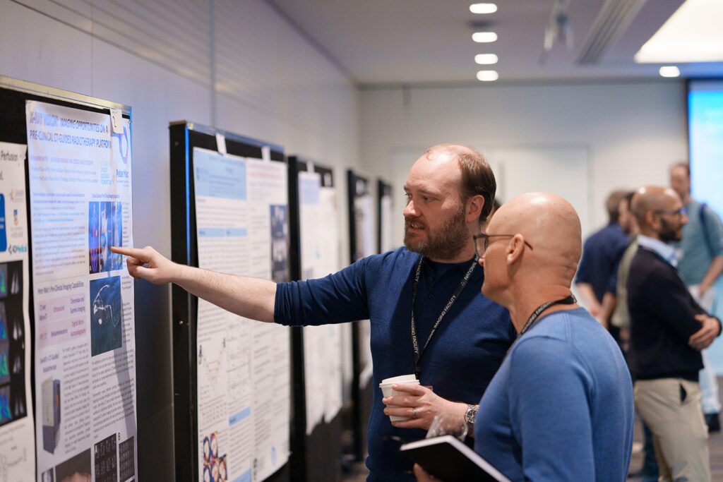 Two people looking at scientific poster at conference