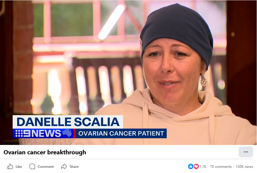 A woman is shown sitting in a house, with a chemotherapy scarf on, dressed in a comfortable hoodie, labeled as Danelle Scalia in the 9 News ovarian cancer patient story